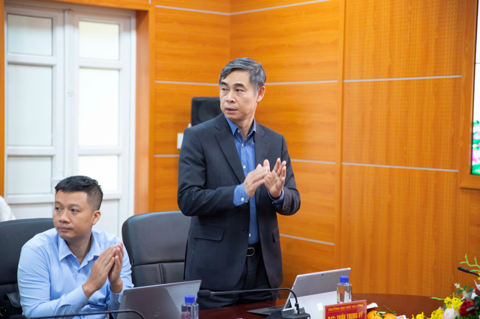 A person in a suit standing in front of a group of peopleAI-generated content may be incorrect.